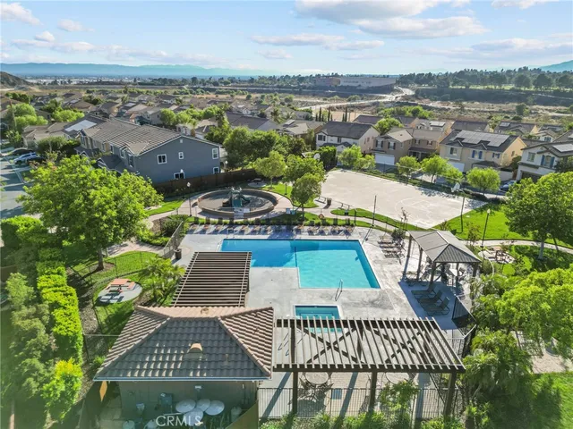 an aerial view of residential houses with outdoor space and trees
