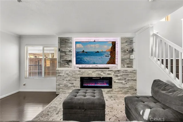 a living room with fireplace furniture and a flat screen tv