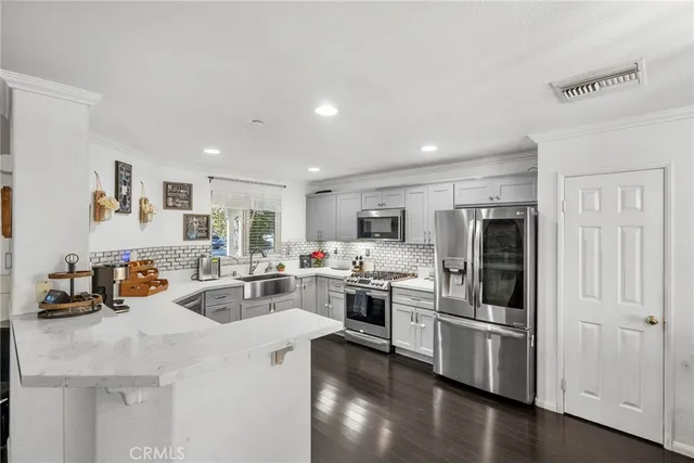 a kitchen with refrigerator and cabinets