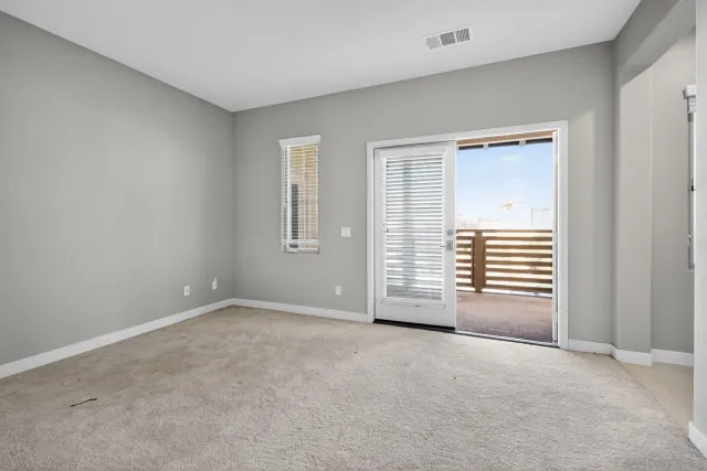 a view of empty room with a fireplace