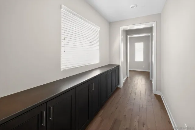 a view of hallway with wooden floor