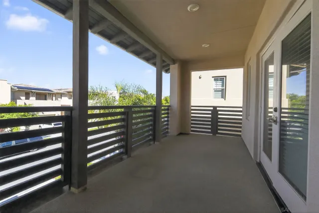 a view of a porch with two chairs and a floor to ceiling window