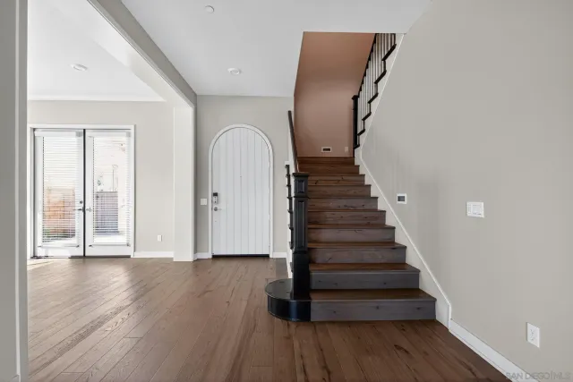 a view of an entryway with wooden floor