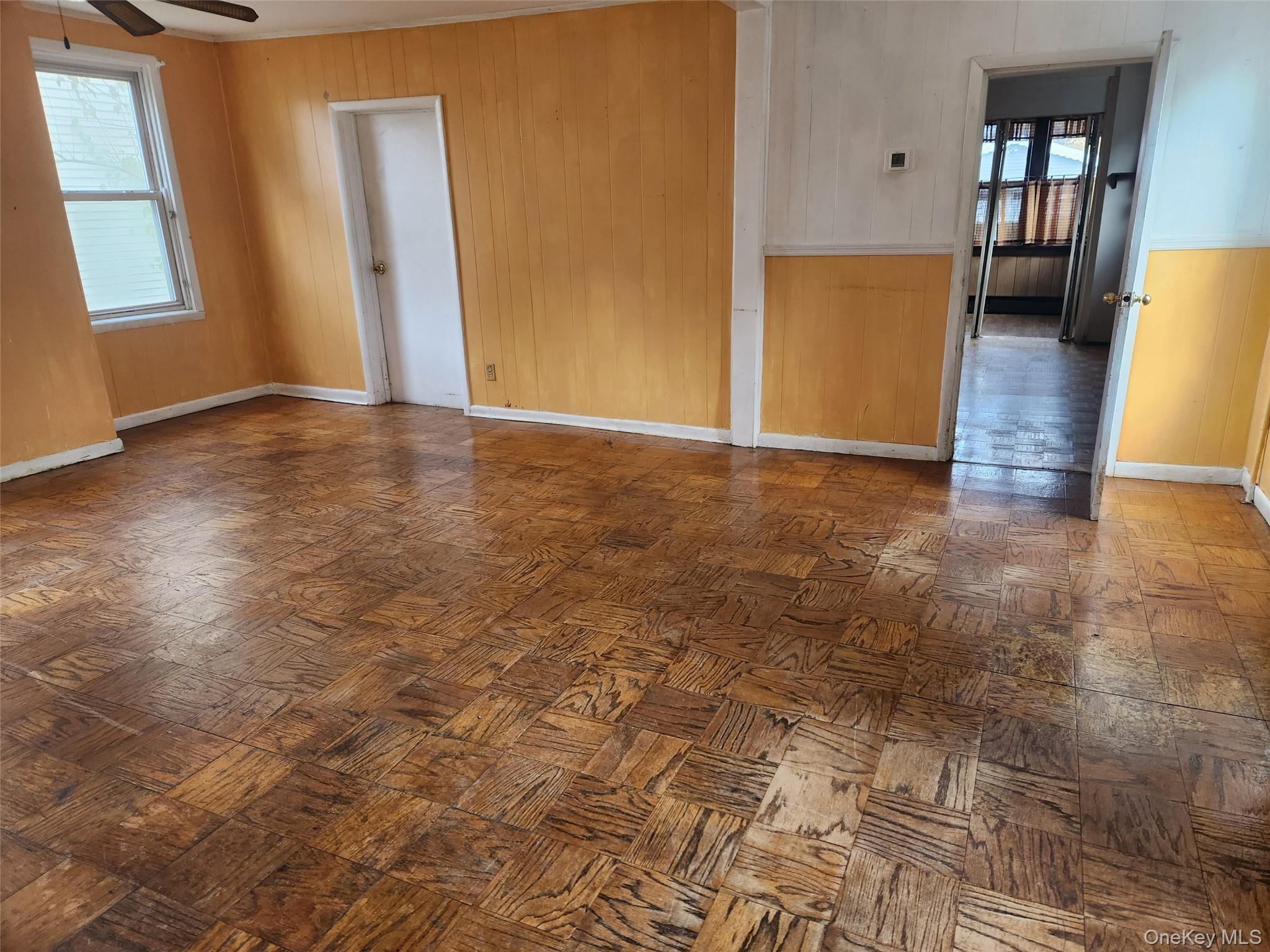 19 Grove Street Beacon, NY 12508 - Photo 12 of 38 Spare room with wooden walls and ceiling fan