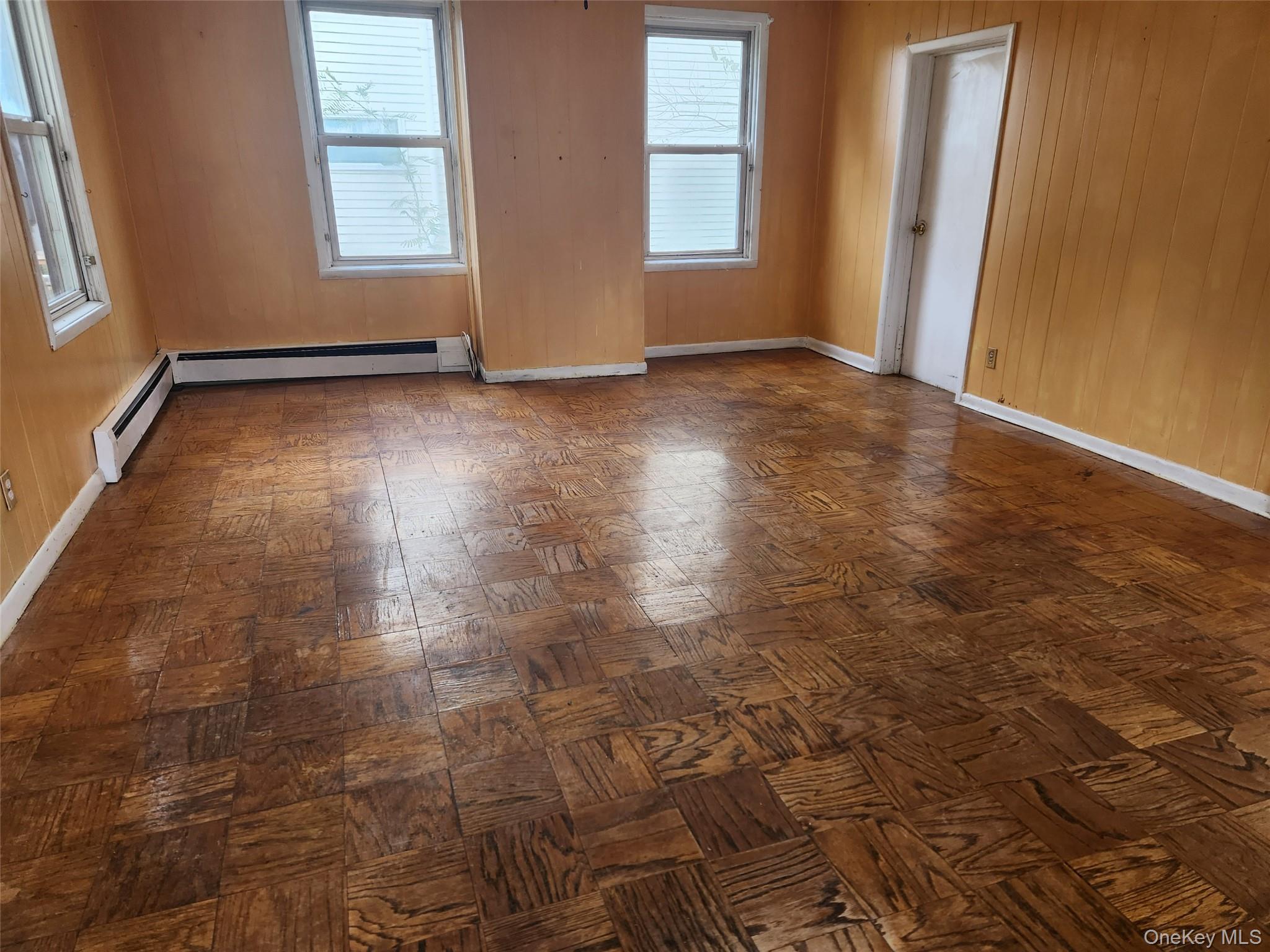 19 Grove Street Beacon, NY 12508 - Photo 13 of 38 Empty room featuring wooden walls and a baseboard heating unit