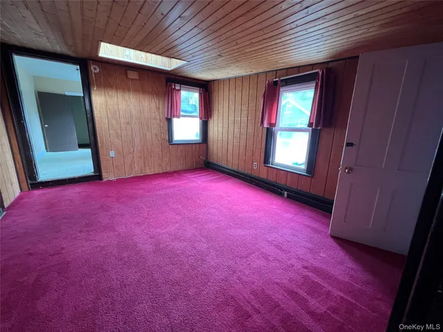 a view of an empty room and wooden floor