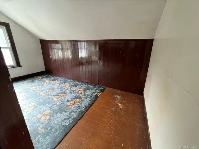 a view of a big room with wooden floor and cabinet