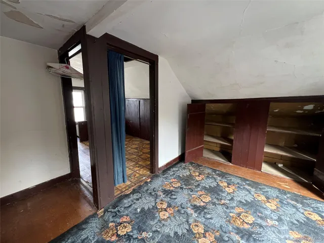 a view of a hallway and an empty room