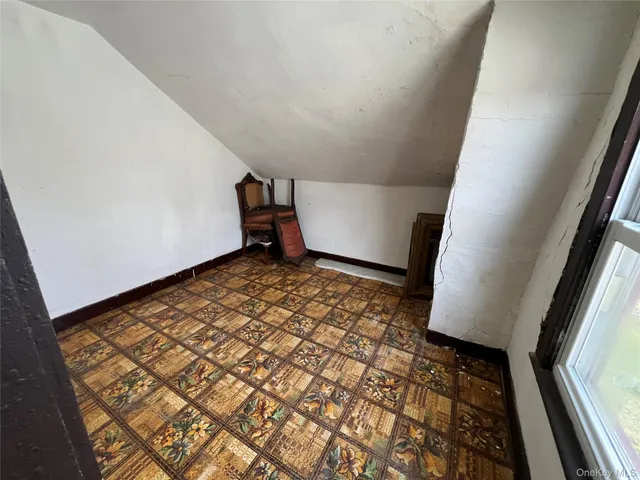 a view of an empty room and wooden floor