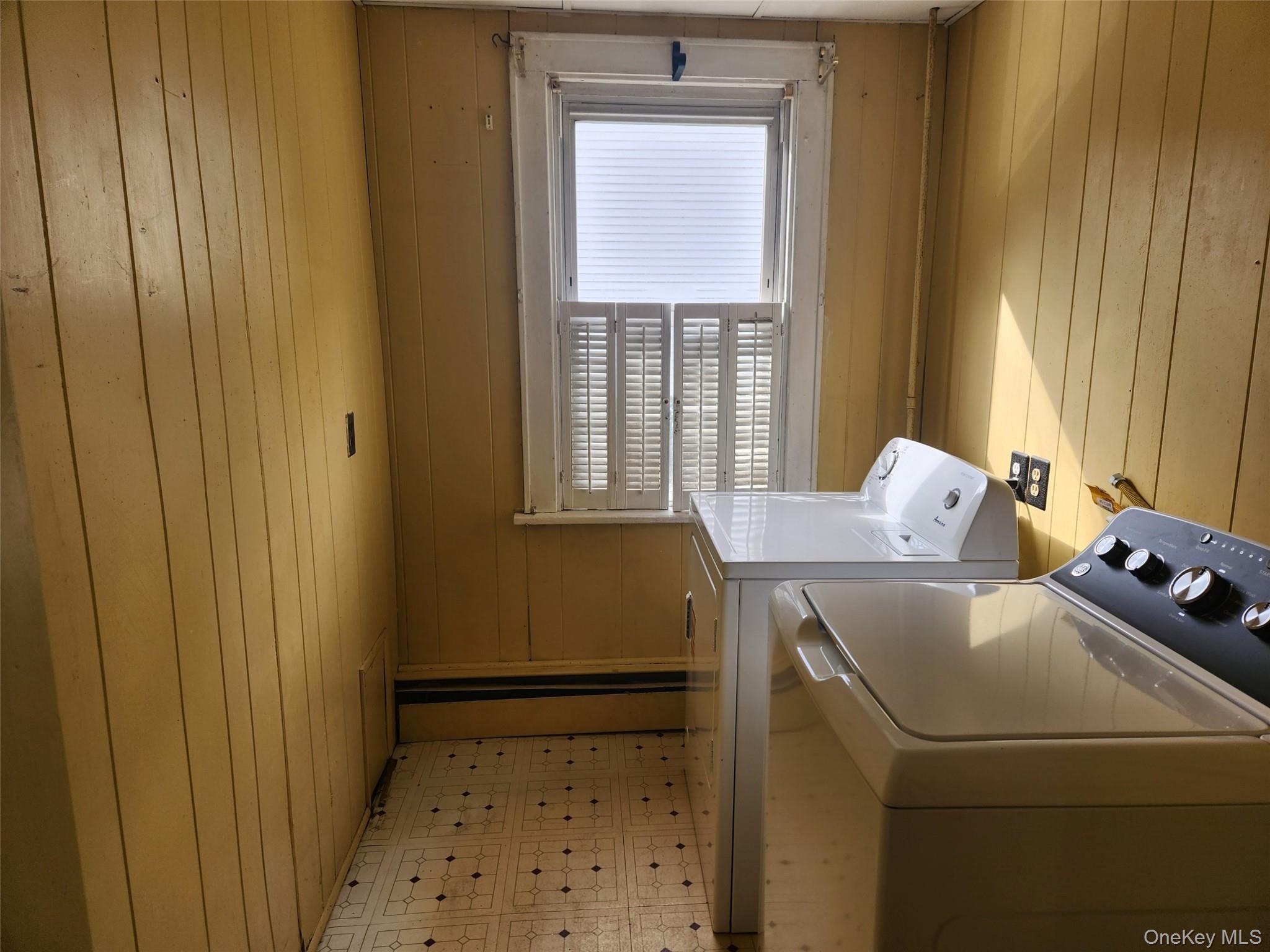 19 Grove Street Beacon, NY 12508 - Photo 10 of 38 Washroom with light floors, washing machine and clothes dryer, and wood walls