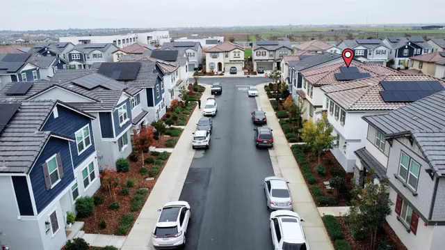 an aerial view of a residential apartment building with a yard