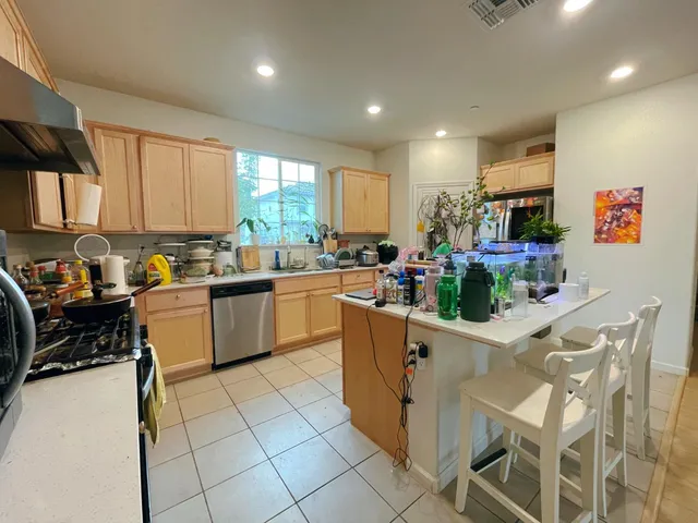 a kitchen with a sink cabinets and window
