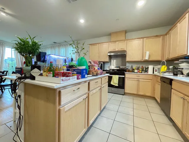 a kitchen with a sink stainless steel appliances and cabinets