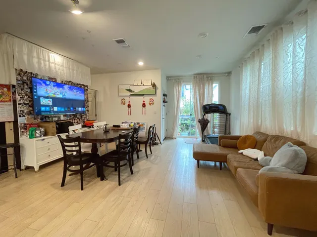 a living room with furniture a rug and a flat screen tv