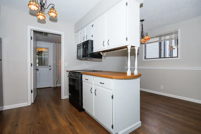 a kitchen with stainless steel appliances a stove top oven a sink and a refrigerator