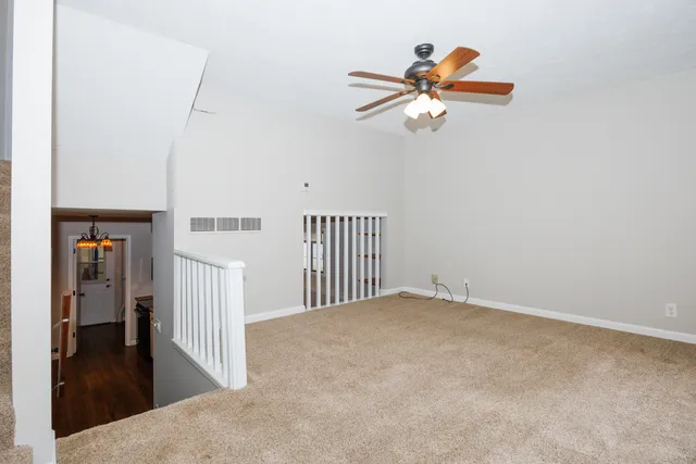 a view of empty room with ceiling fan