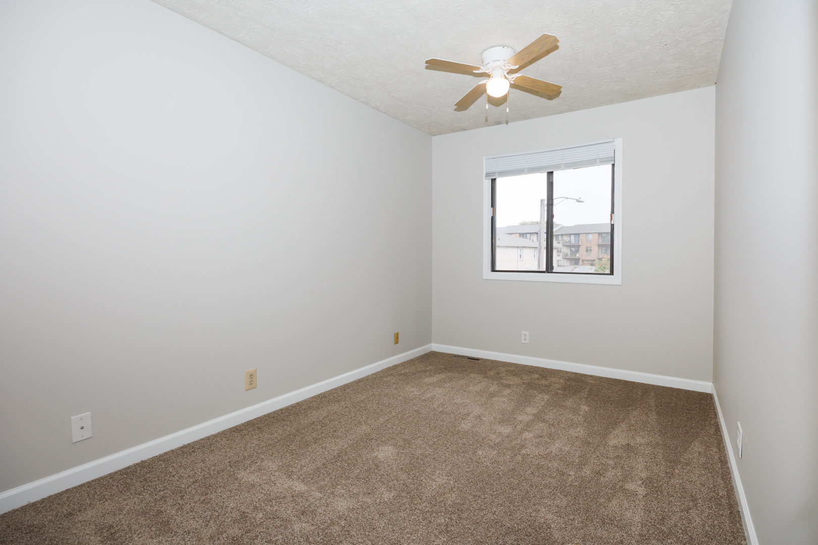 107 North Orr Drive, Unit F Normal, IL 61761 - Photo 25 of 30 an empty room with a window and a fan