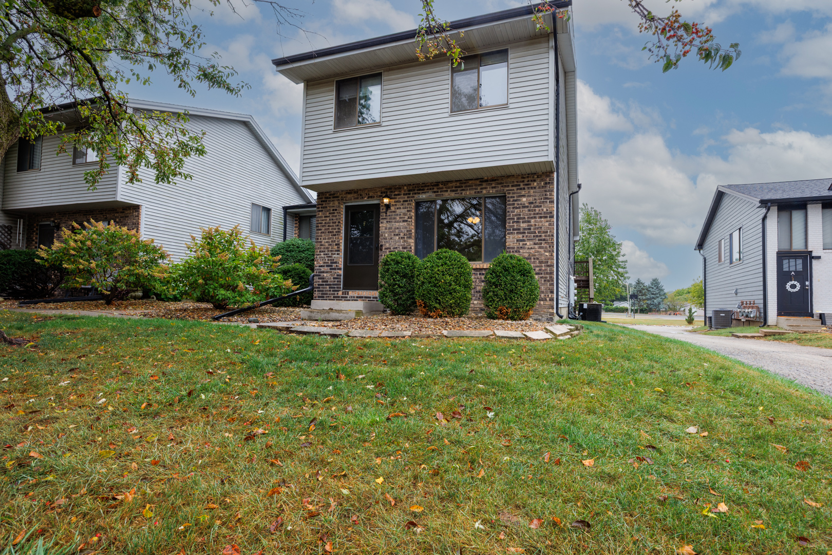 107 North Orr Drive, Unit F Normal, IL 61761 - Photo 30 of 30 a front view of a house with garden
