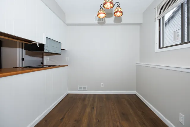 a view of storage and utility room with wooden floor