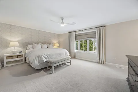 a spacious bedroom with a bed and a window