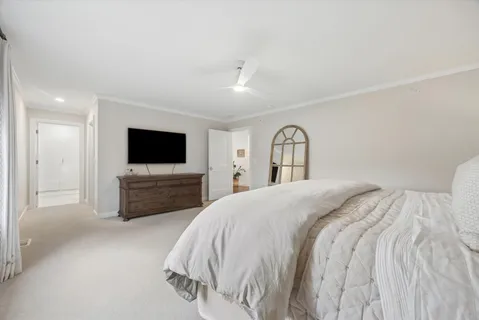 a bedroom with a bed and a flat screen tv