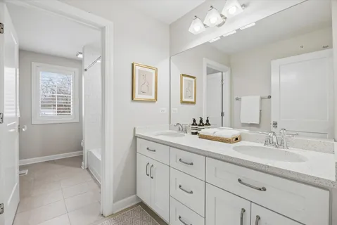 a bathroom with double vanity sink a vanity and a mirror