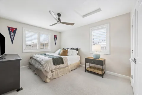 a spacious bedroom with a bed and a window