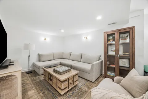 a living room with furniture a rug and a flat screen tv