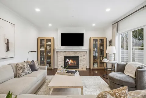 a living room with furniture a fireplace and a flat screen tv