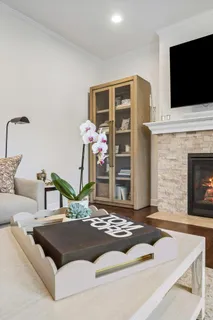a living room with furniture fireplace and flat screen tv