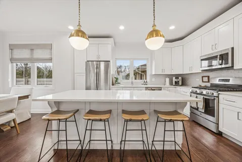 a large kitchen with a table and chairs