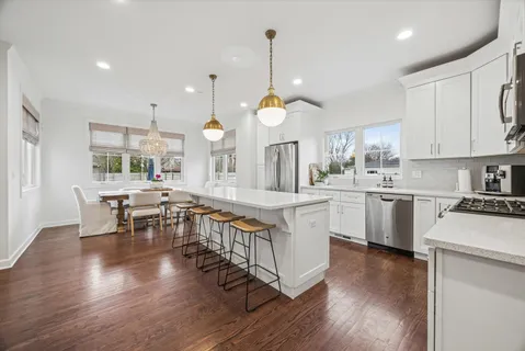a kitchen with counter space dining table and chairs