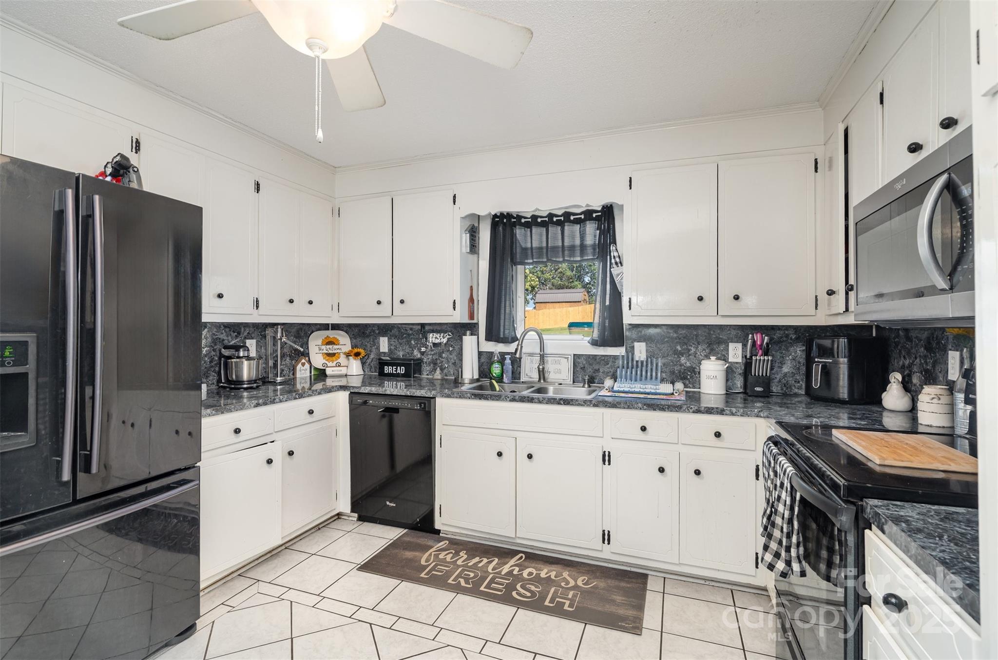 5609 Grace Chapel Road Hickory, NC 28601 - Photo 13 of 29 a kitchen with granite countertop a sink stove and refrigerator