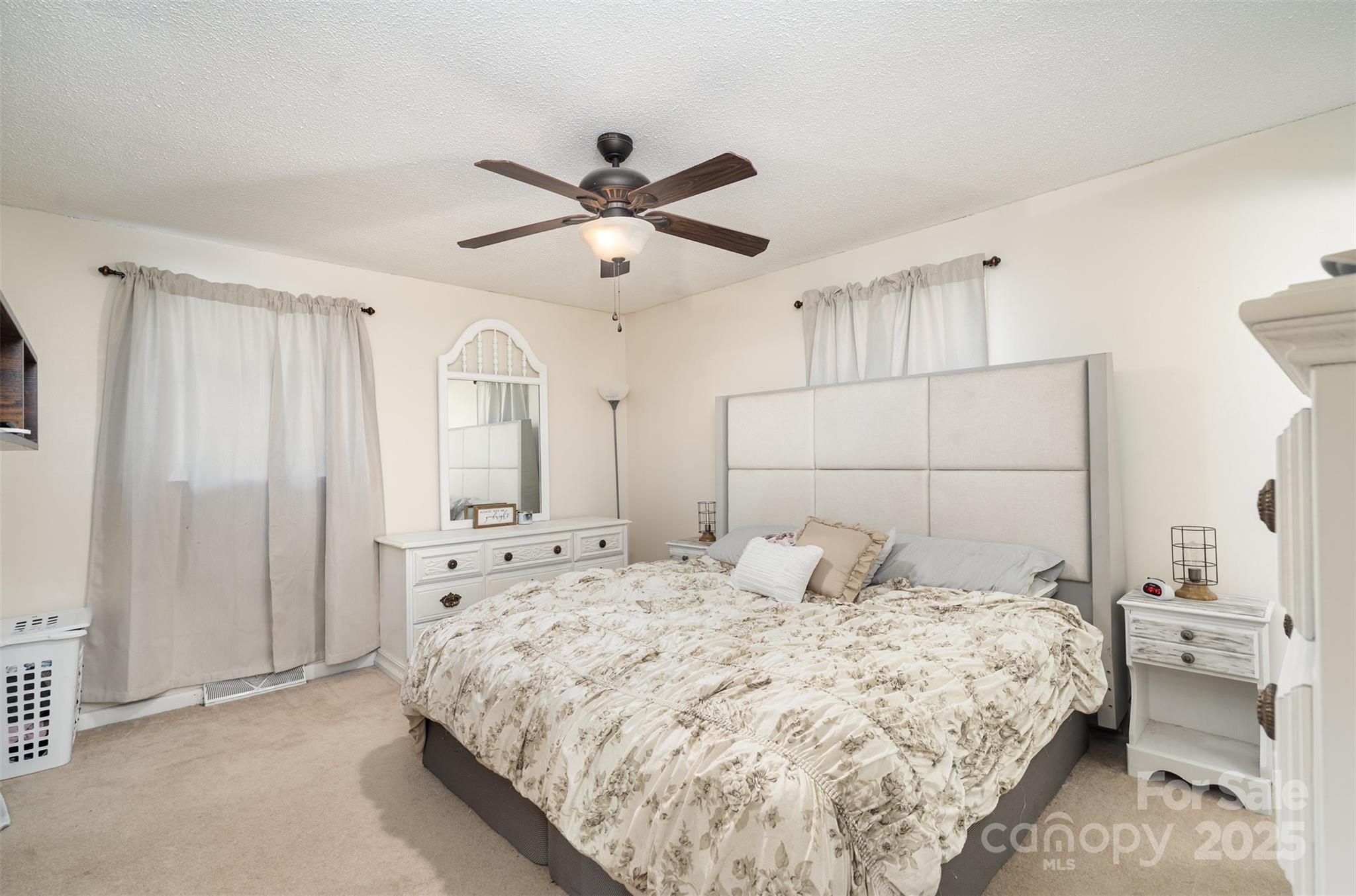 5609 Grace Chapel Road Hickory, NC 28601 - Photo 14 of 29 a bedroom with a large bed and a chandelier