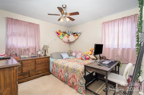 a bedroom with a bed and a desk