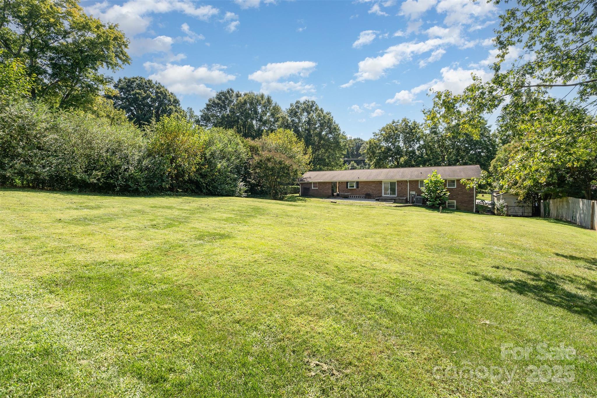 5609 Grace Chapel Road Hickory, NC 28601 - Photo 27 of 29 a view of a swimming pool with an outdoor seating and a forest