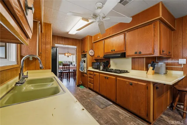 a kitchen with wooden cabinets a sink and a stove