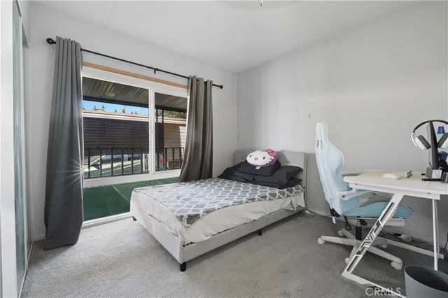 a bedroom with a bed and large window