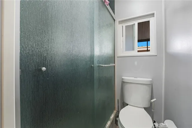 a white toilet sitting next to a bathroom sink