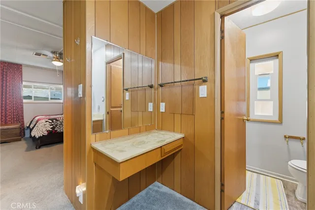 a en suite bathroom with a granite countertop sink and a mirror