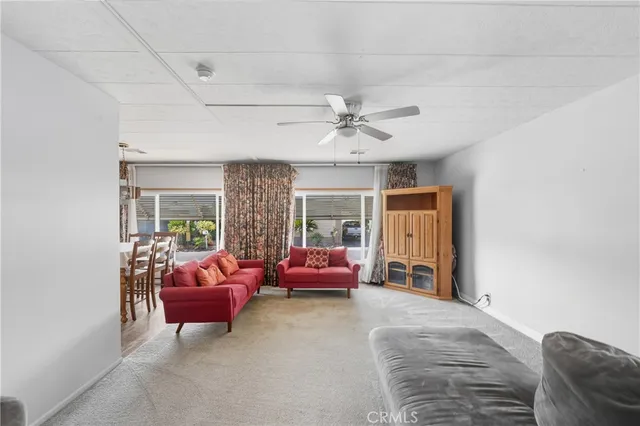 a bedroom with furniture and a large window