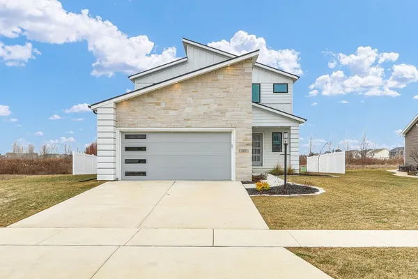 a view of a white house with a yard