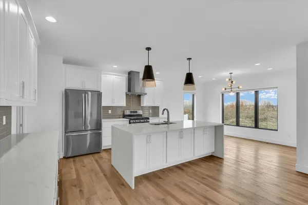 a kitchen with stainless steel appliances granite countertop a refrigerator and a stove