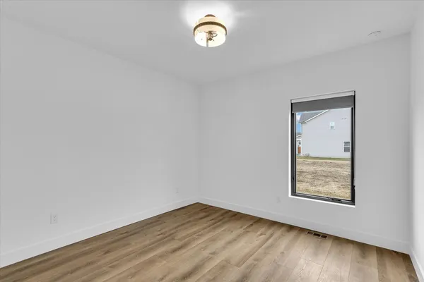 a view of room with wooden floor