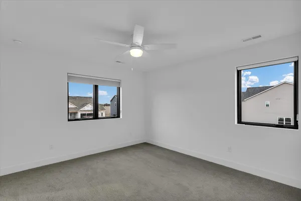 an empty room with a window and wall painting