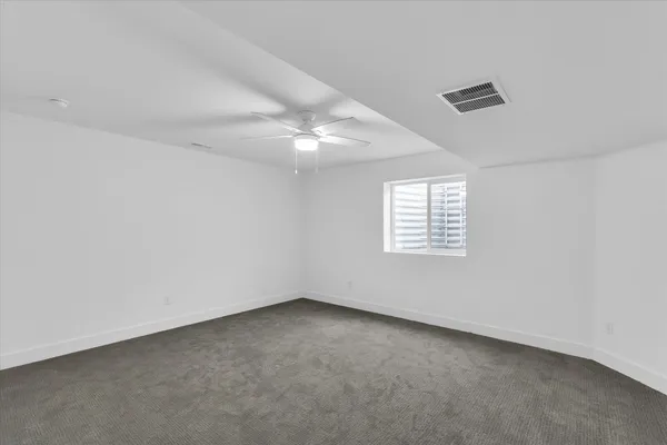 an empty room with a empty space and windows