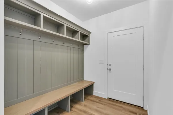 a room with a bench and wooden floor