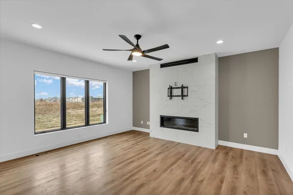 a view of an empty room with a fireplace and a window