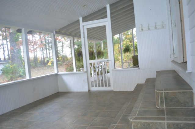 446 Belmont Road Manchester, TN 37355 - Photo 15 of 20 From the backyard, step into the quaint, relaxing screened-in patio. Offering a bead board ceiling (laid board by board), recessed lighting, tile flooring, & access to the Den, backyard, or attached covered patio.