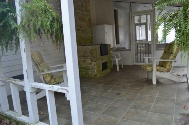 446 Belmont Road Manchester, TN 37355 - Photo 16 of 20 The Covered Patio also offers the tile flooring. This space is the perfect area to enjoy the tranquility of the yard with a good book & glass of sweet iced tea. This area offers a built in grill flanked with hand laid stone & a storage box.